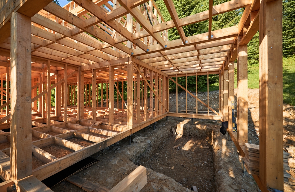 Residential,wooden,frame,house,under,construction,near,a,forest.,beginning