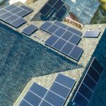 Aerial,view,of,american,home,roof,with,blue,solar,photovoltaic